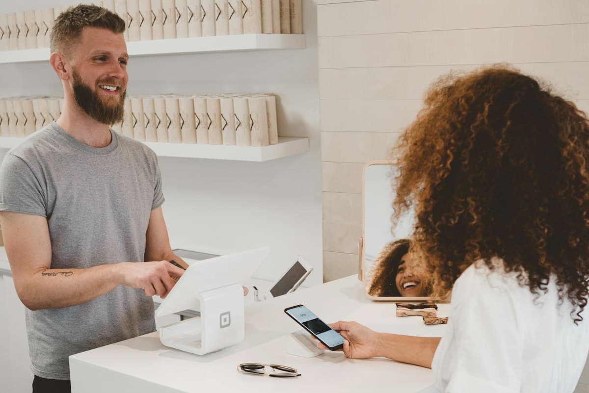 A customer completing a payment at a shop counter